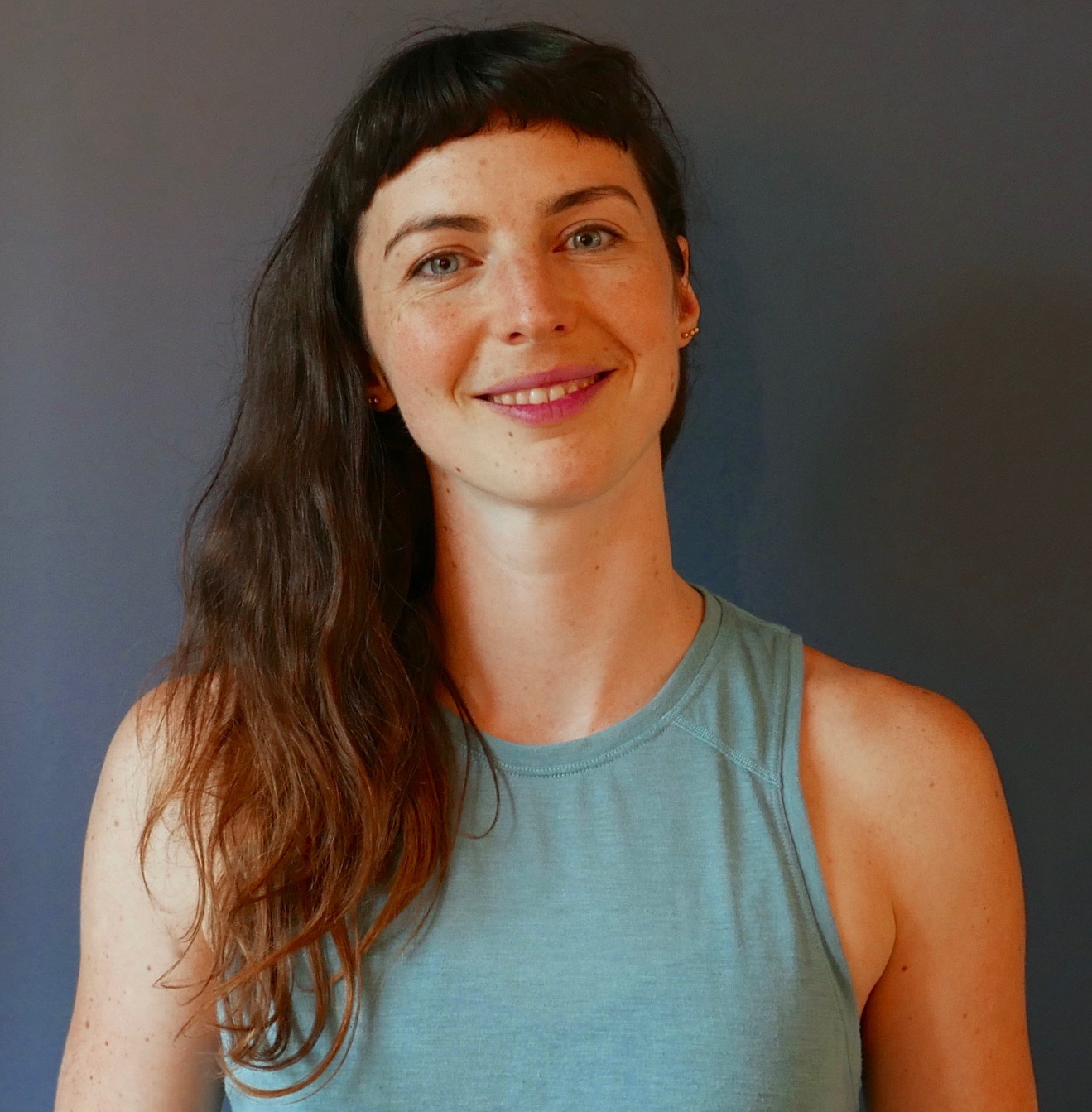 Joelle in a wide-legged forward fold yoga pose